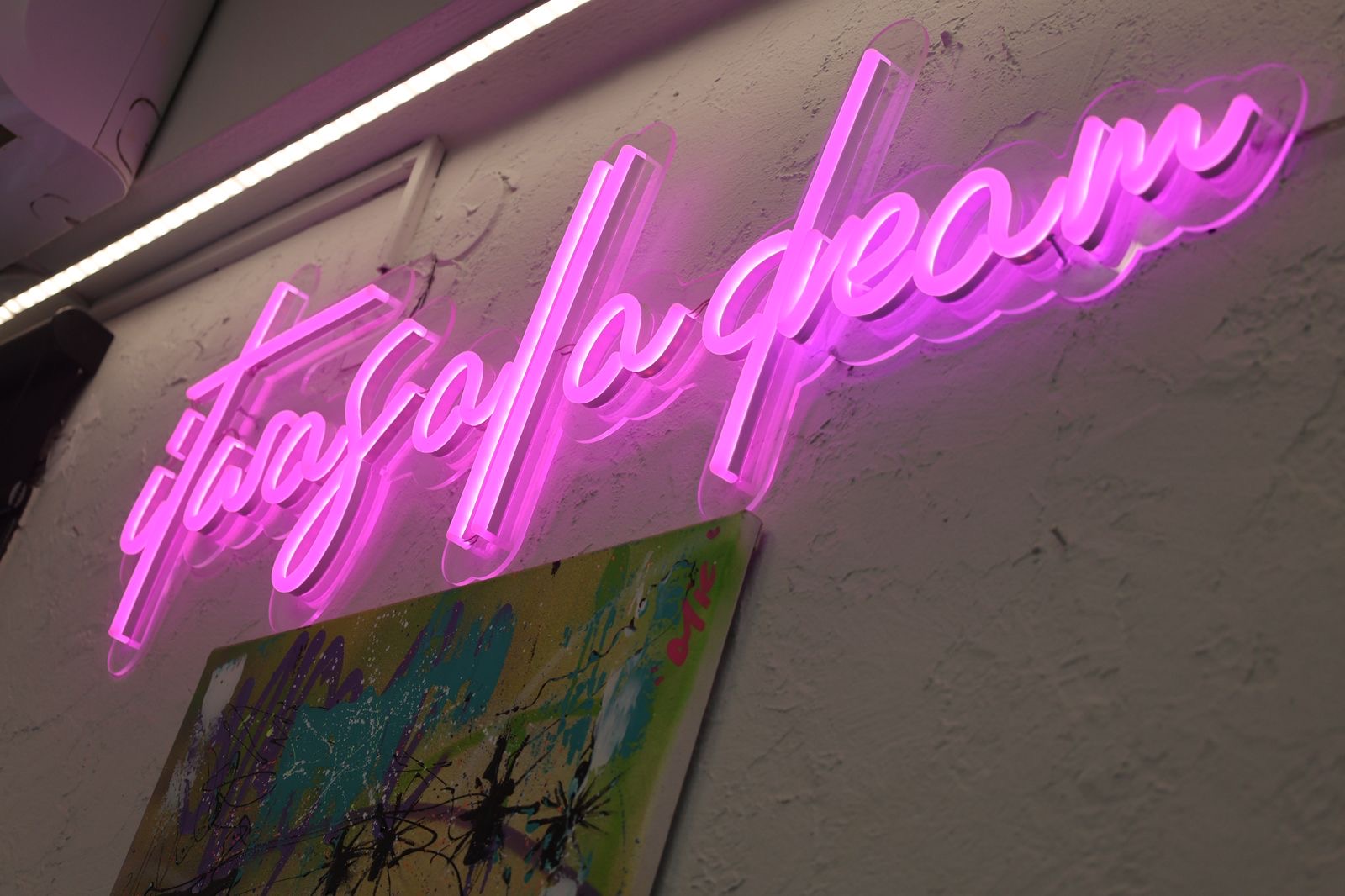 Neon script signage inside Mykonos Ink Tattoo studio